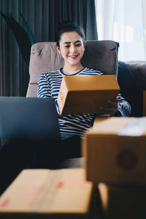 Asian small business owner working at home office. Business retail market and online sell marketing delivery, SME e-commerce concept.の写真素材