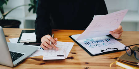 Business woman working to analyze technical price graph and indicator. account or saving money or insurance conceptの写真素材