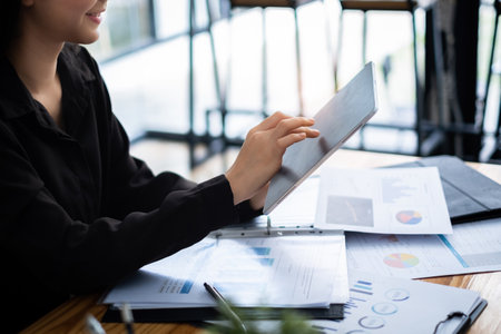 A businesswoman completes KYC using an online banking program in order to open a digital savings account. The definition of cyber security.の写真素材