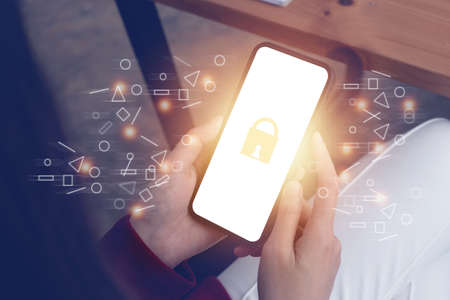 Business Finance and Accounting Concept. Business woman using security application on smartphone to protect her money.の写真素材
