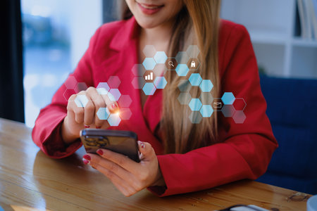Business Finance and Accounting Concept. Business woman using security application on smartphone to protect her money.の写真素材