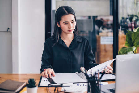 Frustrated stressed business financial or accountant sitting at office and analyze with paperwork.の写真素材