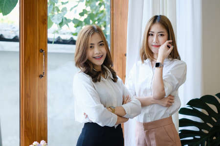 Smiling and happy Asian businesswoman working together in office. Finance and Accounting concept.の写真素材