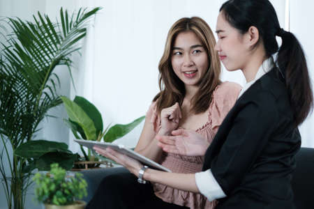 Insurance agent offers and explain health insurance life plan for elderly. asian woman choosing plan of life and saving Insurance.の写真素材