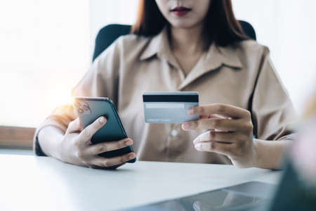 Woman enjoy with online shopping application and typing credit card for fill number to payment with virtual digital assetの写真素材