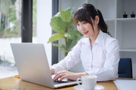 E-learning ,online ,education and internet social distancing protect from viruses concept. Asian woman student video conference e-learning with teacher on digital tablet at home.の写真素材