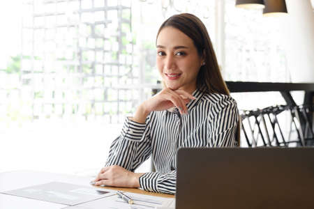 Asian Business Woman or Accountant with paperwork on desk, account, audit and saving concept.
