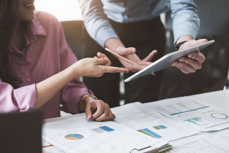 Asian Business consultant working together by digital tablet and management big data and analyze financial budget of company. Fund investment concept.の写真素材