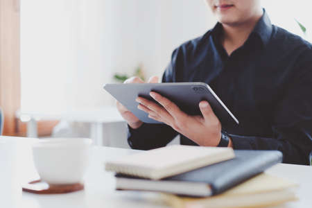 Businessman using digital tablet at office, account or saving money or insurance concept.の写真素材