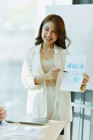 Business people discussing and consulting marketing plan at exclusive meeting room.