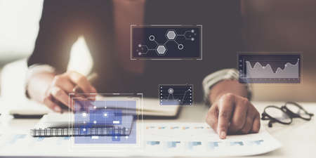 Business woman hand holding pencil and financial paperwork looking at bank savings account application on laptop computer. account or saving money or insurance concept.の写真素材