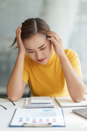Asian business woman worry about marketing plan of this years. Finance concept.の写真素材