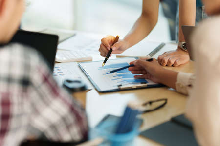 Group of Businesswoman and Accountant checking data document on digital tablet for investigation of...