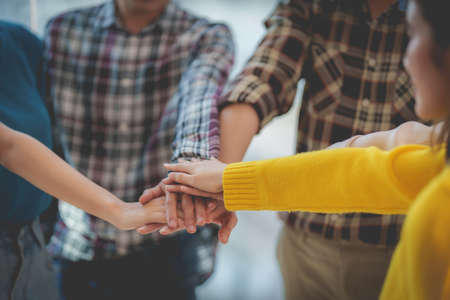 Group of Multiracial people putting their hands working together showing oneness symbol.の写真素材