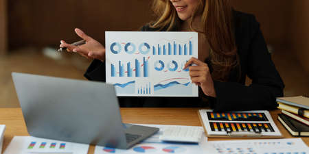 Businesswoman teacher or mentor coach speaking to customer about financing by video call. Finance...