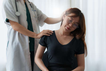 Doctor or Physiotherapist working examining treating making neck massage. Rehabilitation therapy concept.の写真素材