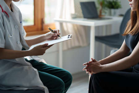 Doctor consulting patient and offer healthy food nutrition at clinic.の写真素材