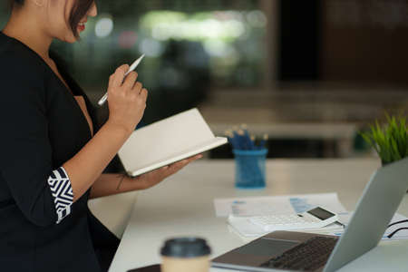 Beautiful Asian Business woman watching educational webinar on laptop computer. Finance concept.