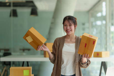 Asian small business owner working at home office. Business retail market and online sell marketing delivery, SME e-commerce concept.の写真素材