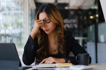 Asian business woman worry about marketing plan of this years.