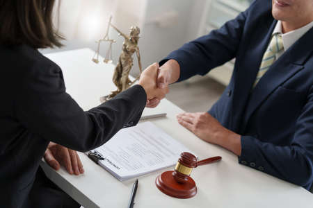Business woman and lawyer shaking hand after discussing about agreement contract. Law, legal services, advice, Justice concept.の写真素材