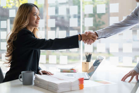Business partnership meeting concept. Image business women handshake. Successful business people handshaking after good deal. Group support concept.の写真素材