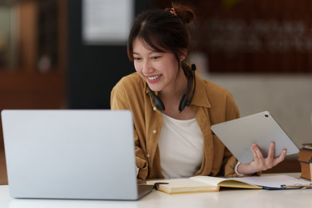 E-learning ,online ,education and internet social distancing protect from COVID-19 viruses concept. Asian woman student video conference e-learning with teacher on laptop computer at home.の写真素材