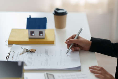 Woman sign in agreement contract for loan or buy house. Real Estate concept.