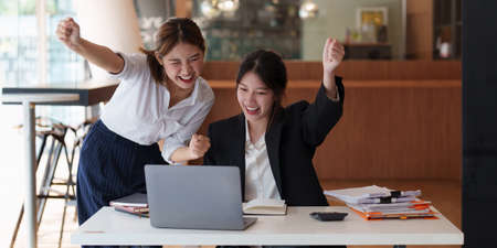 Successful business team excited when her business growth. Finance concept.