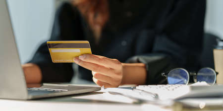 Woman using online payment and holding credit card. Online Shopping concept.の写真素材