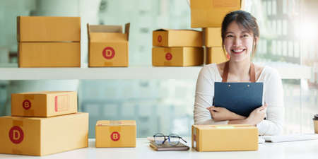 Young asian freelance packing boxes for commercial. SME e commerce concept.