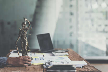 Lawyer holding Scales of Justice of set up desk in office. Law, legal services, advice, Justice concept.の写真素材