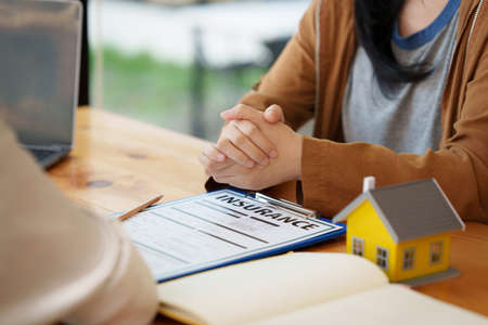 Real Estate Agent explain insurance and agreement contract to client before sign contract.の写真素材