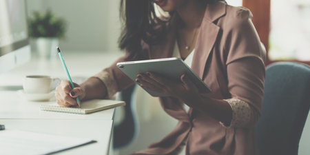Business woman using digital tablet at office, account or saving money or insurance concept.の写真素材