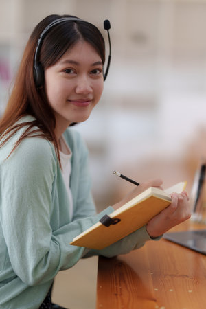 Young college student have question and answer to teacher by video call. E-learning ,online ,education concept.の写真素材