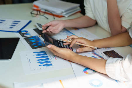Group of Businesswoman and Accountant checking data document on digital tablet for investigation of...