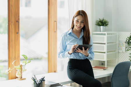 A portrait of Asian happy Businesswoman smiling and working at office.の写真素材