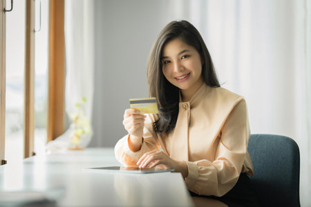 Portrait of Asian Woman using online payment and holding credit card. Online Shopping concept.の写真素材