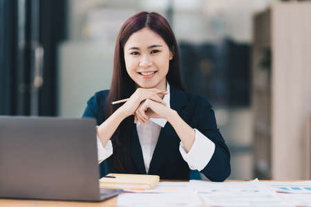 Business Finance audit tax Concept. Portrait of Asian happy Businesswoman smiling and working at office.の写真素材