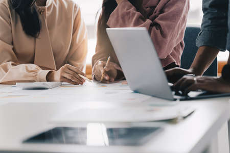 Group of business people working at workplace. Business team hands at working with financial plan,...