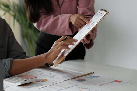 Group of business people working at workplace. Business team hands at working with financial plan,...