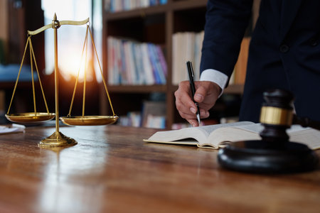 Close up lawyer businessman working or reading lawbook in office workplace for consultant lawyer...