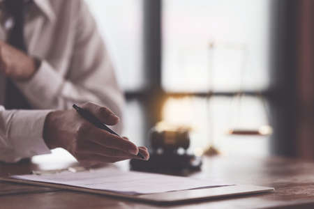 Close up lawyer businessman working or reading agreement contract in office workplace for consultant...