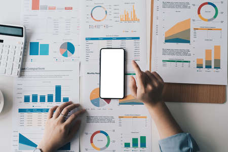 Business woman using cell phone with bank savings account application, account or saving money or insurance concept.の写真素材