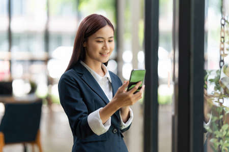 Business woman completes KYC using an online banking program in order to open a digital savings account. The definition of cyber security.の写真素材
