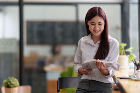 Business woman working or reading lawbook in office workplace for consultant lawyer concept.の写真素材
