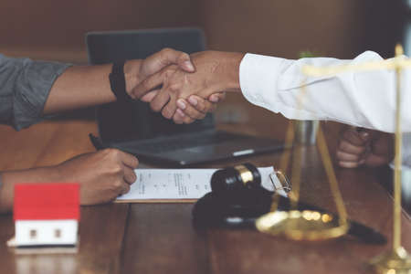 Business person and lawyer shaking hand after discussing about agreement contract. Law, legal services, advice, Justice concept.の写真素材