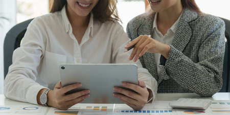 Fund managers team consultation and discuss about analysis Investment stock market by digital tablet.の写真素材