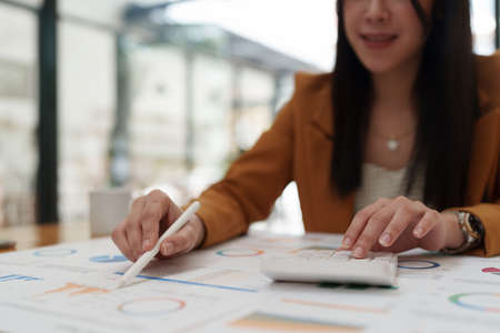 Attractive Asian business woman working with a laptop to audit financial at office. Account concept.の写真素材