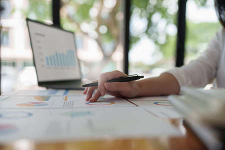 Businesswoman analyzes company financial system and using calculator.の写真素材